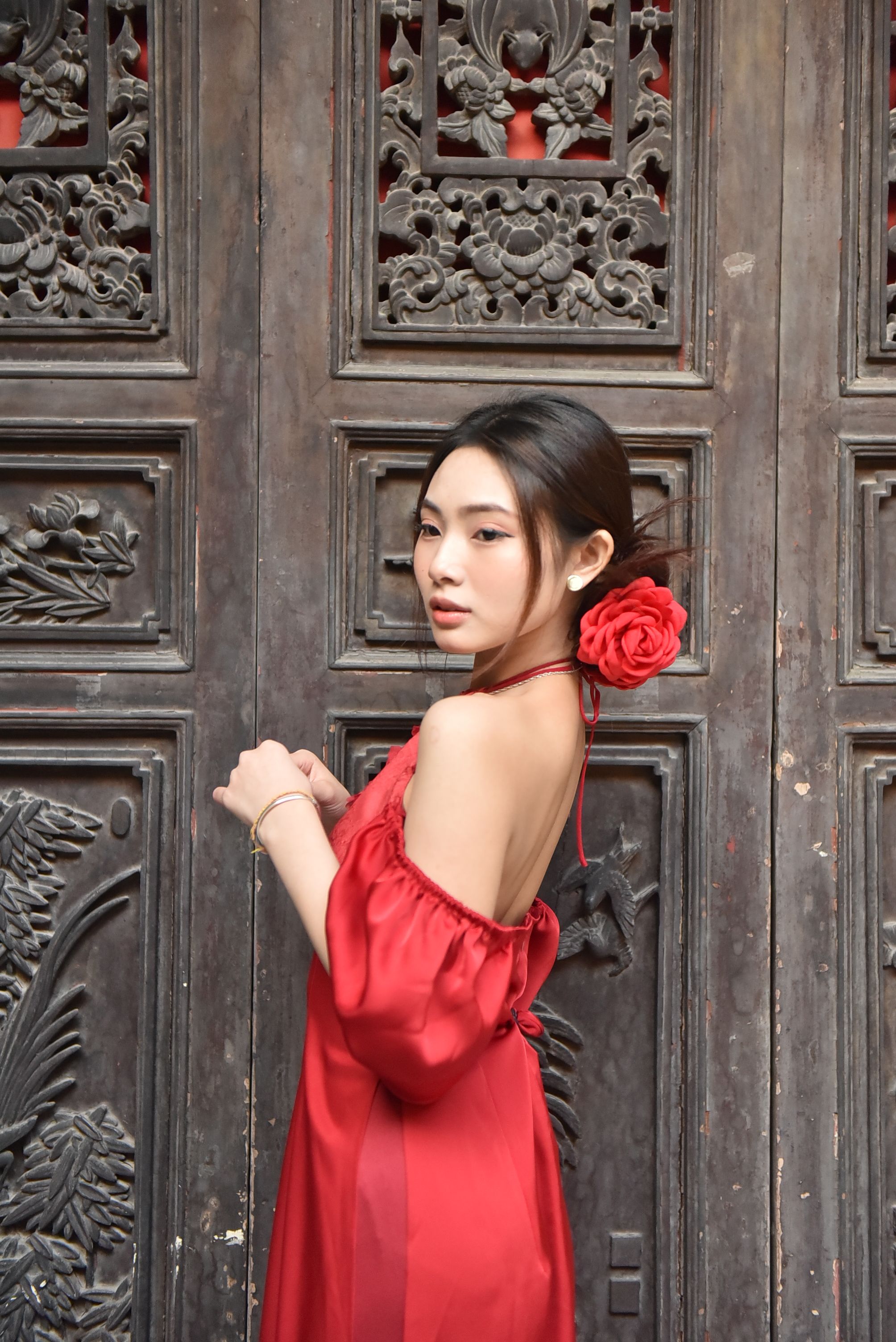 Elegant Woman in Red Dress by Ornate Wooden Door · Free Stock Photo