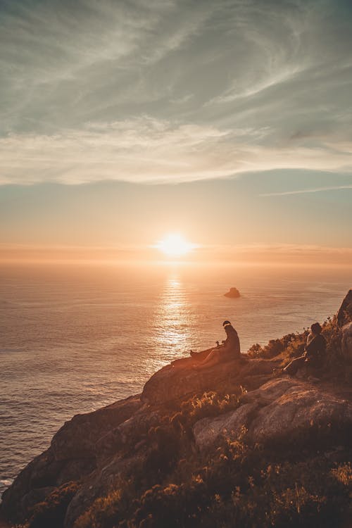 People Sitting By The Cliff