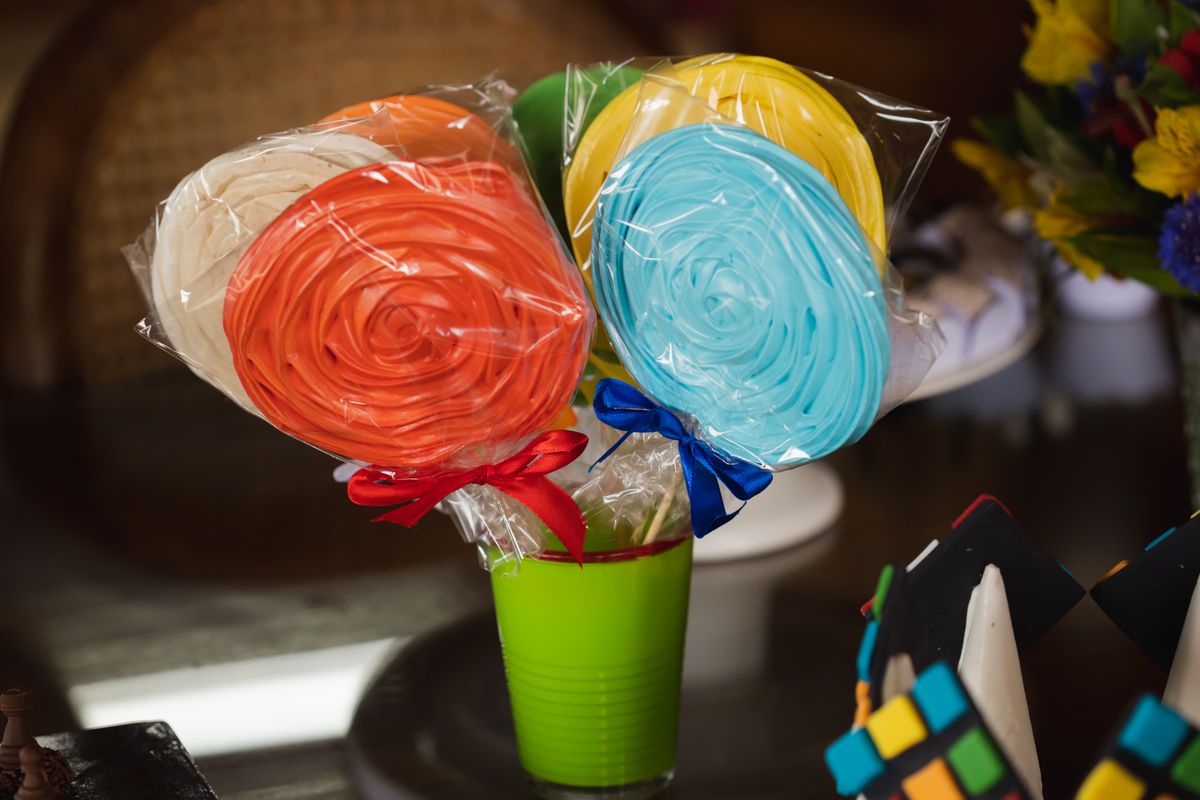 Brightly colored candy lollipops wrapped in cellophane, perfect for festive occasions.