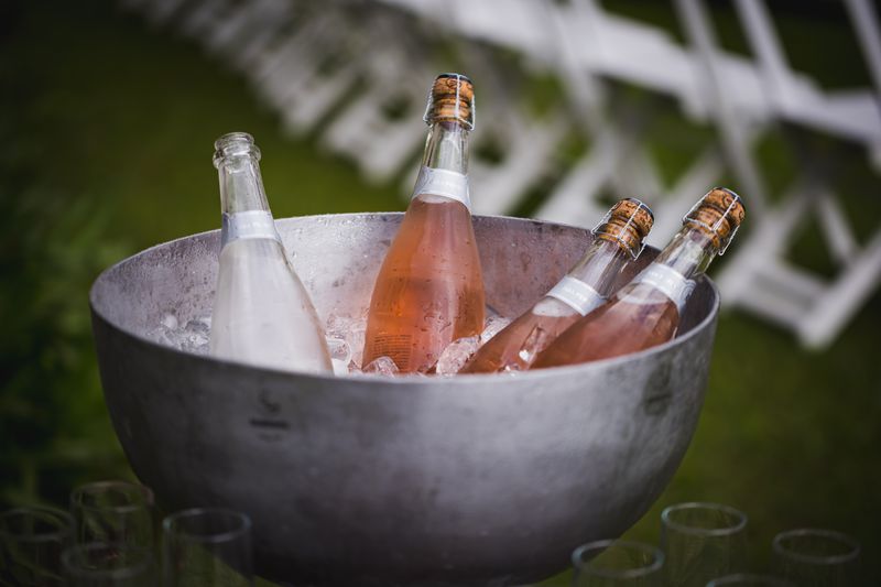 Sparkling wine bottles resting on ice — photo by Bruno Mattos on Pexels