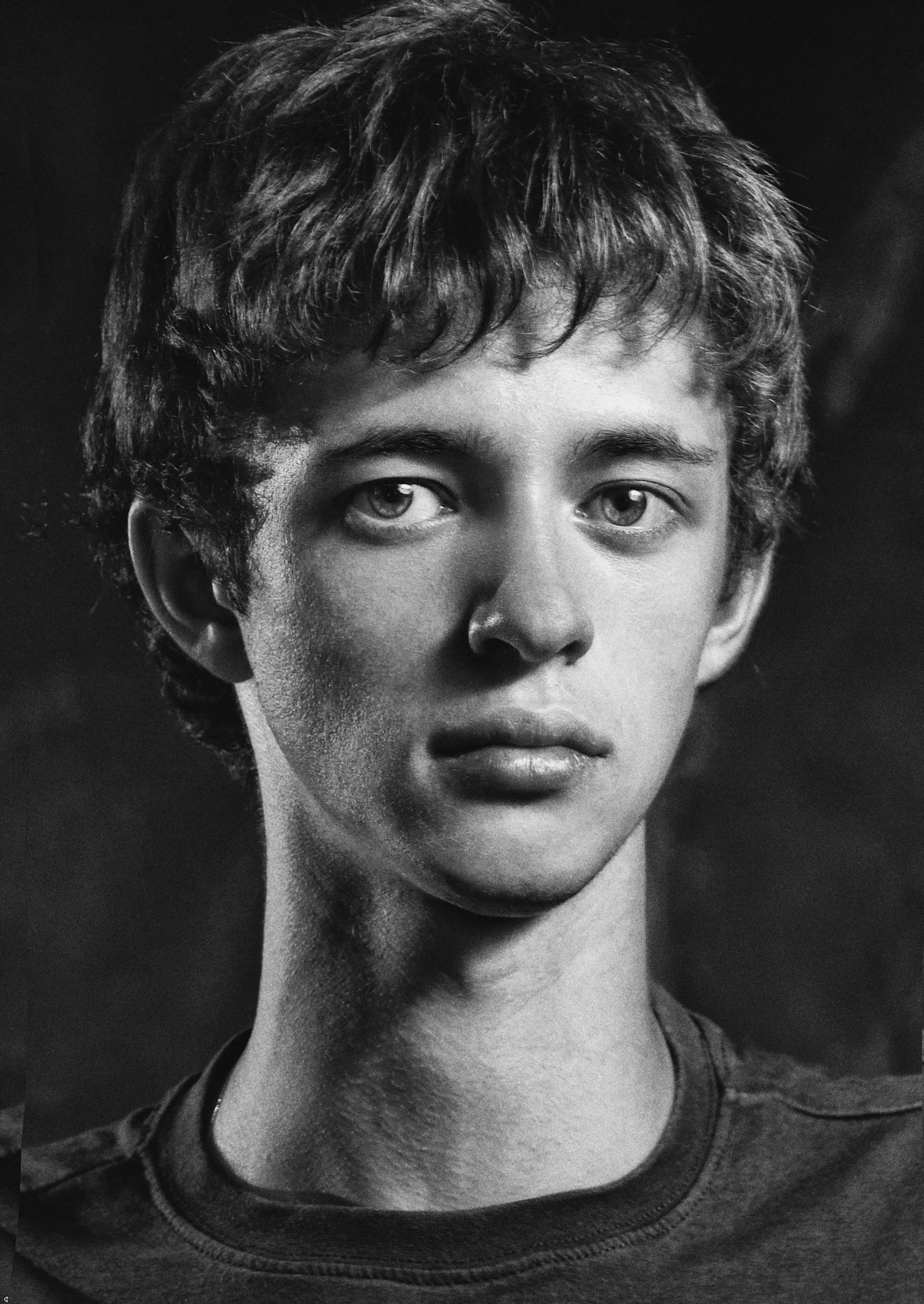 Expressive monochrome portrait capturing a young man's intense gaze.