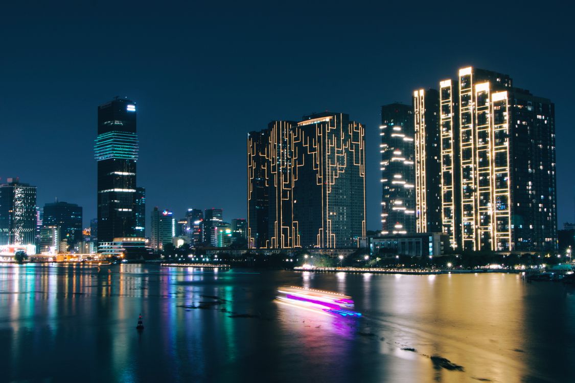 Vibrant City Skyline at Night with Illuminated Buildings · Free Stock Photo