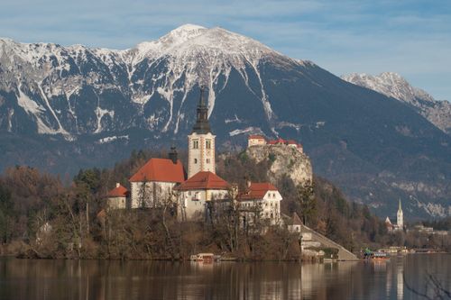 Free Scenic view of Bled Island and Church against the backdrop of Julian Alps in winter. Stock Photo