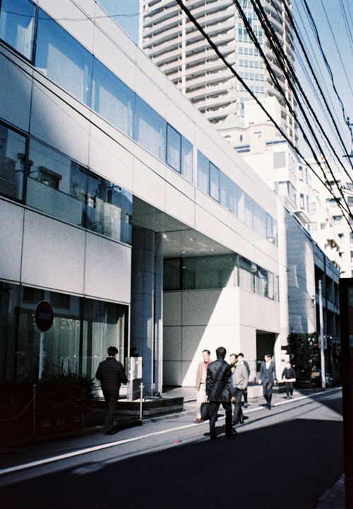 Free Street scene with pedestrians and modern buildings in Tokyo, Japan. Stock Photo