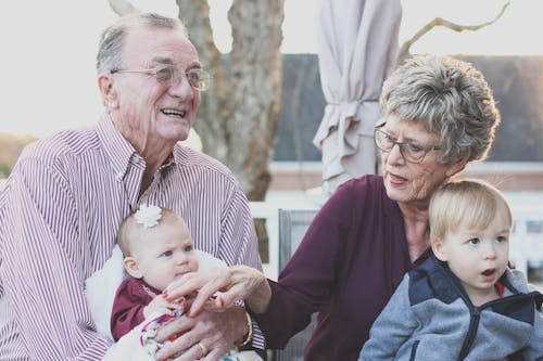 Grootmoeder En Grootvader Met Kind Op Schoot