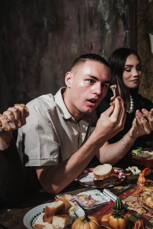 Free A group of friends enjoying Thanksgiving dinner together indoors. Stock Photo