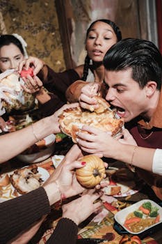 A lively thanksgiving dinner scene with friends enjoying food together.