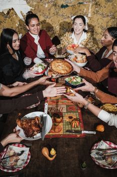 A joyful family celebrating Thanksgiving with a festive dinner spread.