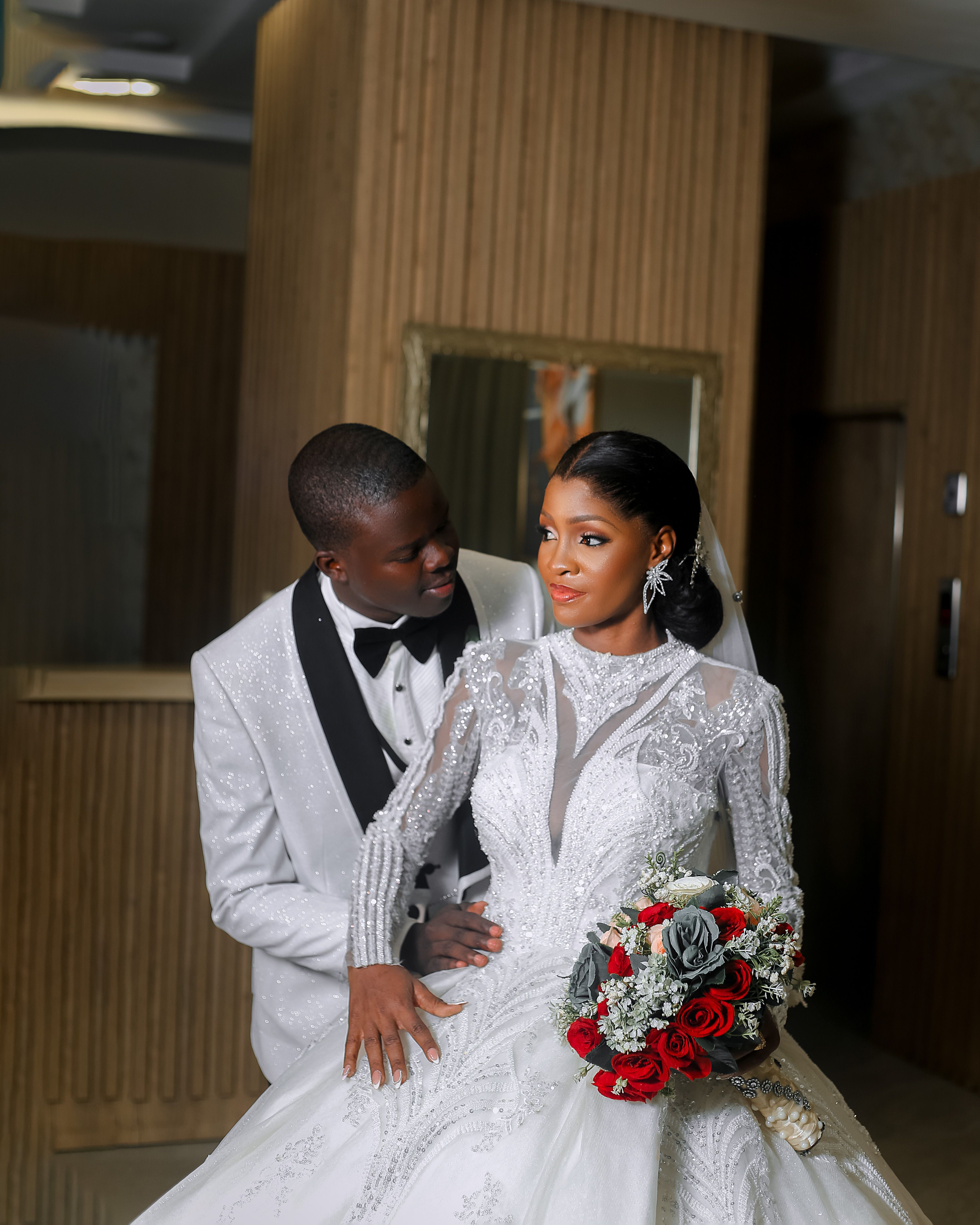 Elegant indoor wedding couple portrait with bouquet