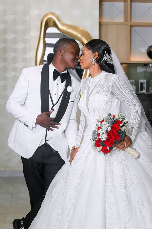 Free Close-up of a bride and groom in elegant wedding attire sharing a romantic moment. Stock Photo