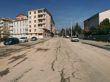 Wide urban street view with cars and residential buildings in Elâzığ, Türkiye.