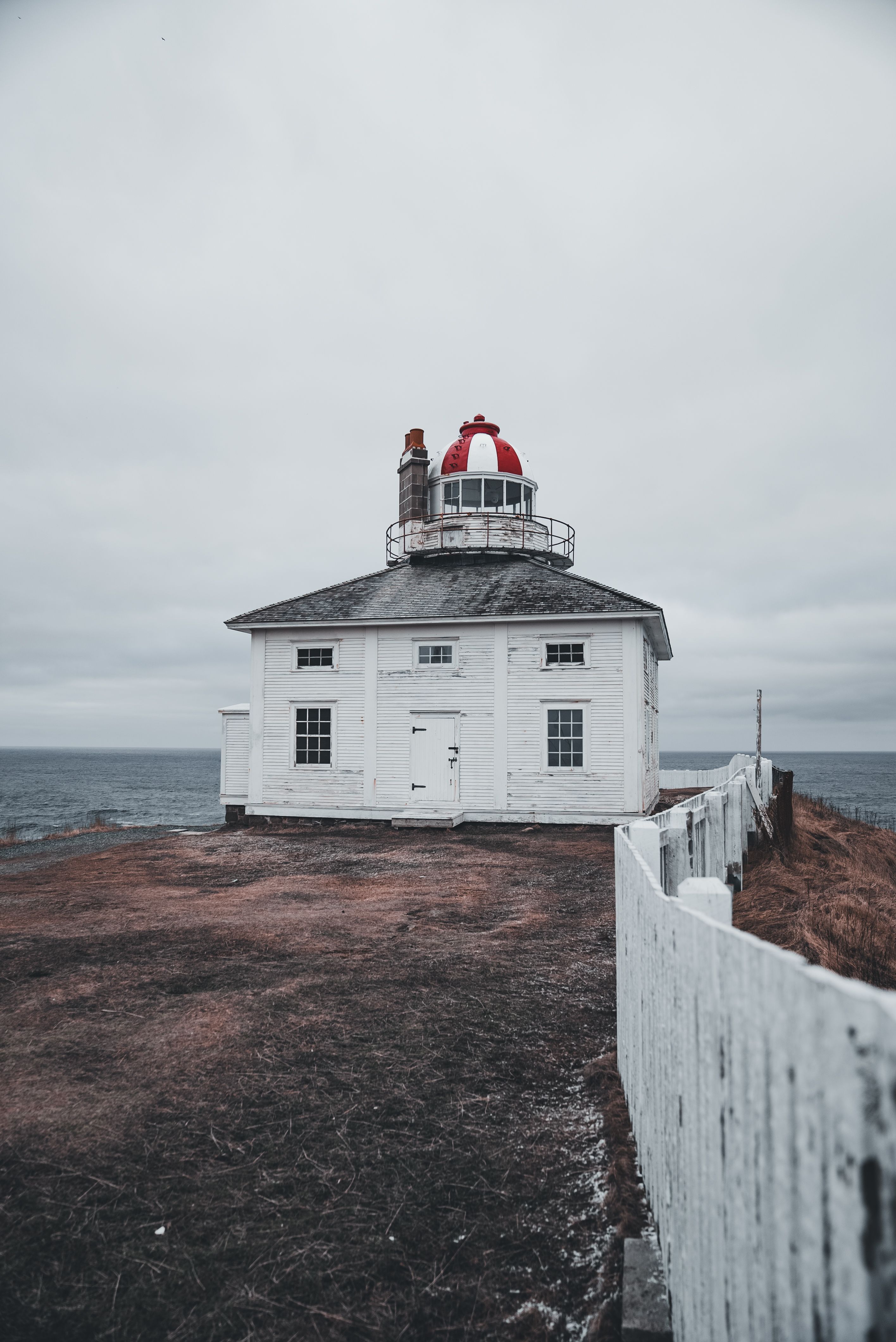Seaside Lighthouse on a Cloudy Day · Free Stock Photo