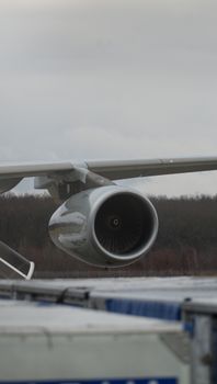 Detailed view of a commercial airplane's jet engine on the runway, highlighting aviation technology.