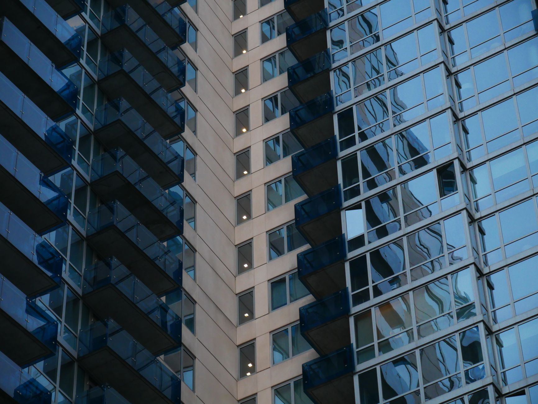 Close-up of a modern skyscraper facade in New York City with reflective glass windows.