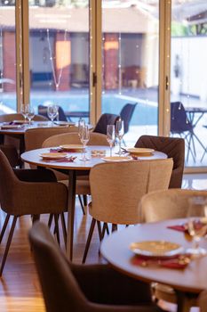 Sophisticated dining setting with an outdoor pool view, ideal for upscale dining experiences.
