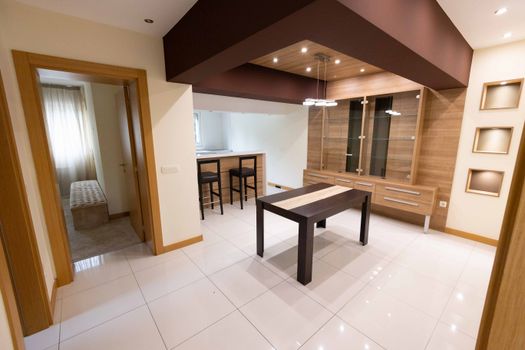 Spacious modern dining room with minimalist decor and elegant wooden features.