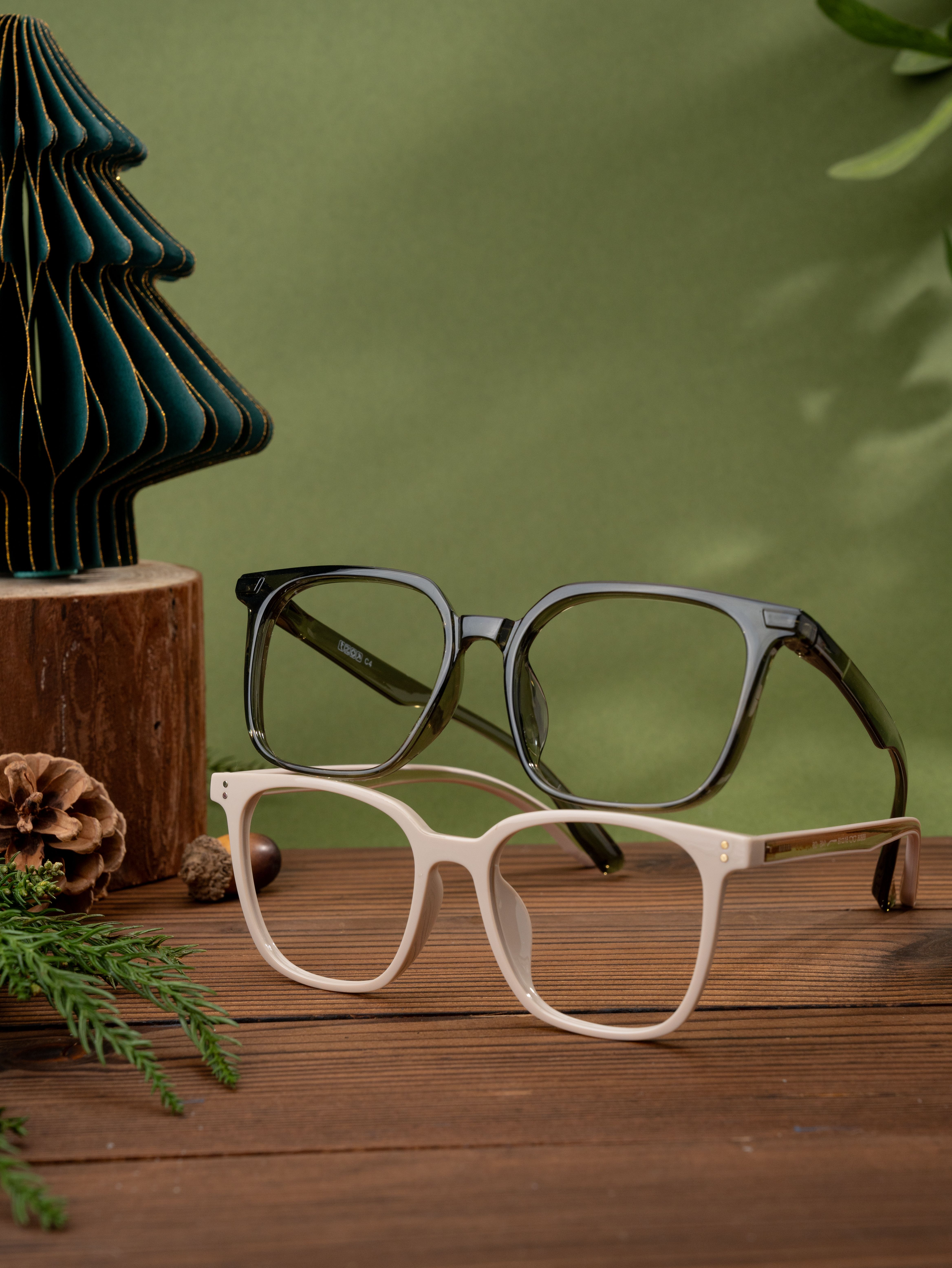 Stylish eyeglasses displayed with pine and wood elements for a cozy aesthetic.