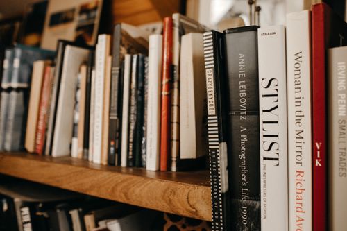 Free A cozy bookshelf setting showcasing assorted hardcover books emphasizing literature and knowledge. Stock Photo