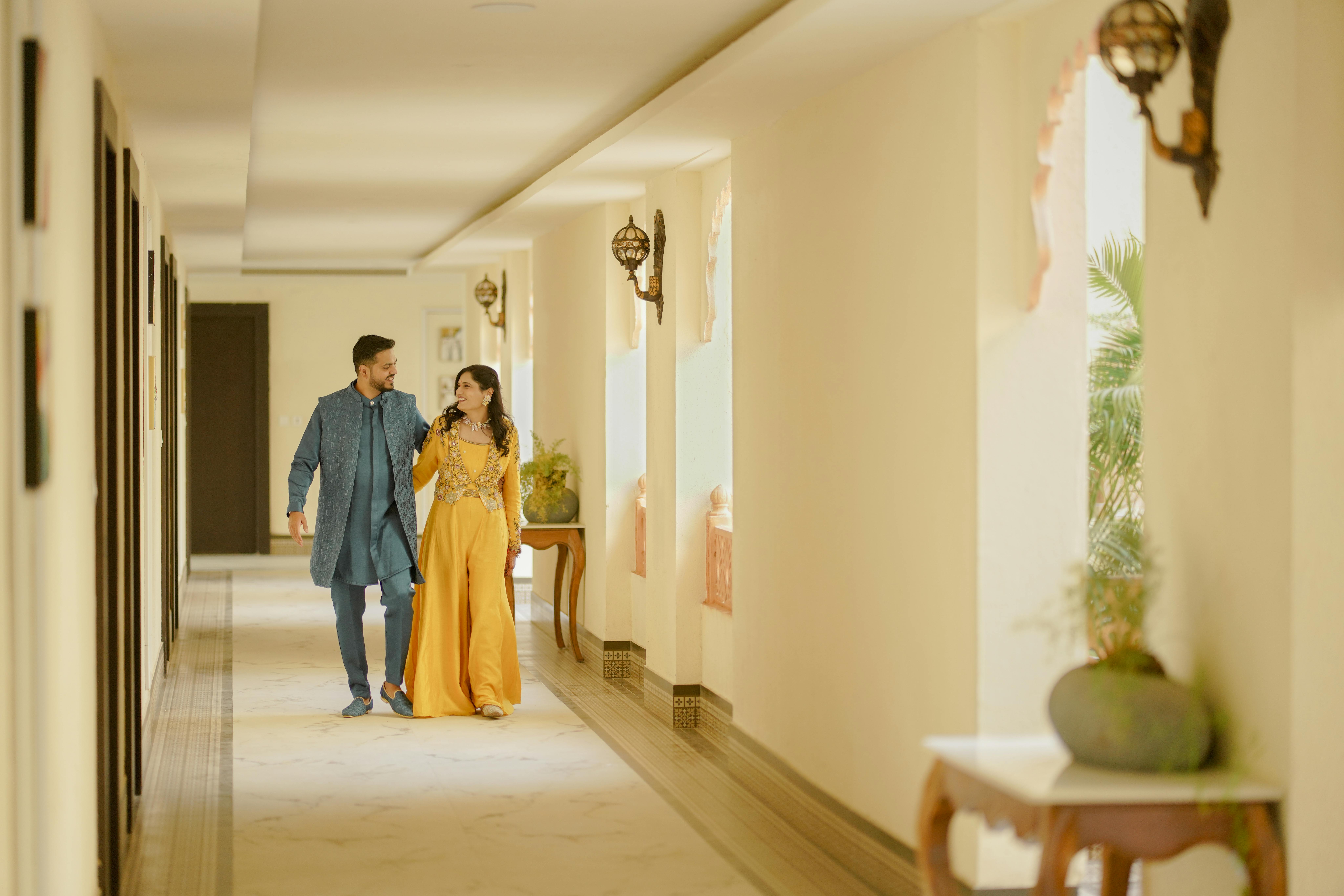 Casal em um corredor iluminado do Palacio Guaqui em Arequipa, destacando o luxo histórico.