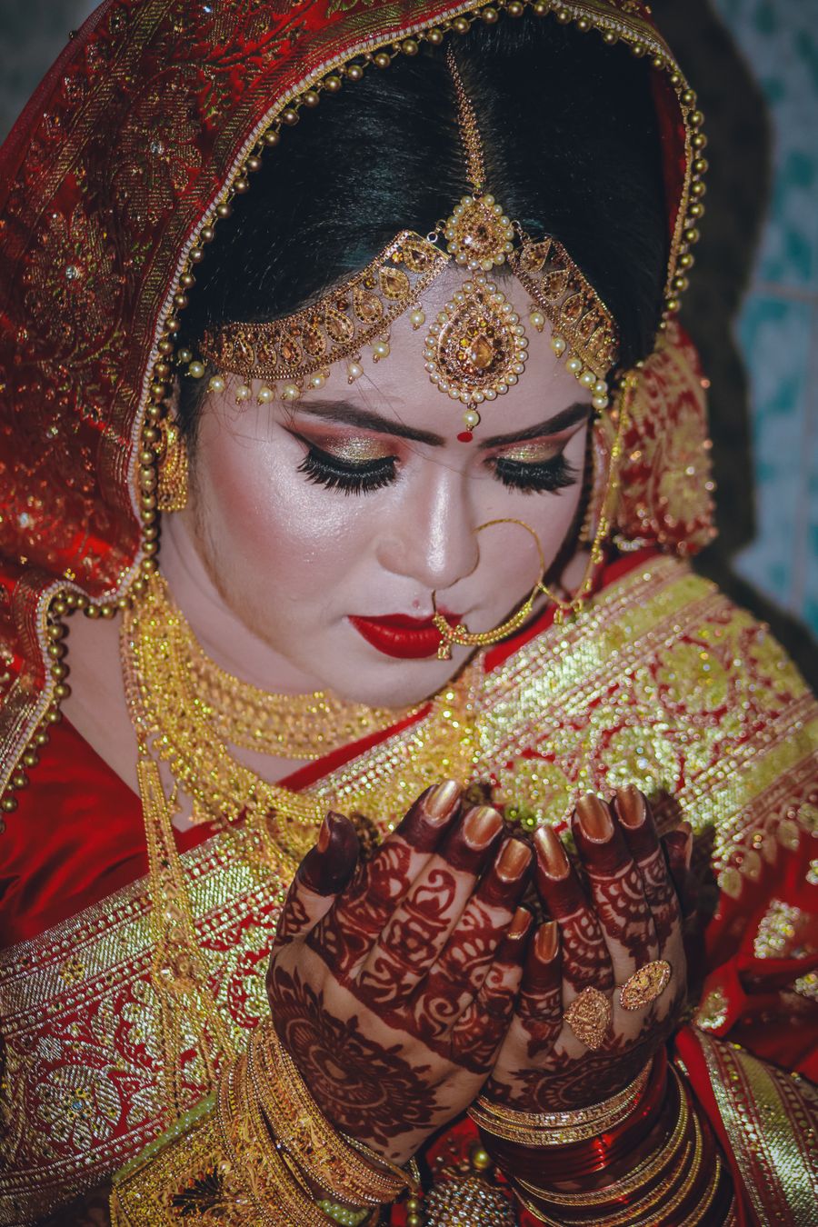 Traditional Indian bridal makeup with henna and jewelry in Guntur
