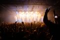 Crowd at a concert under moving lights, photo by Jeremy Li on Pexels