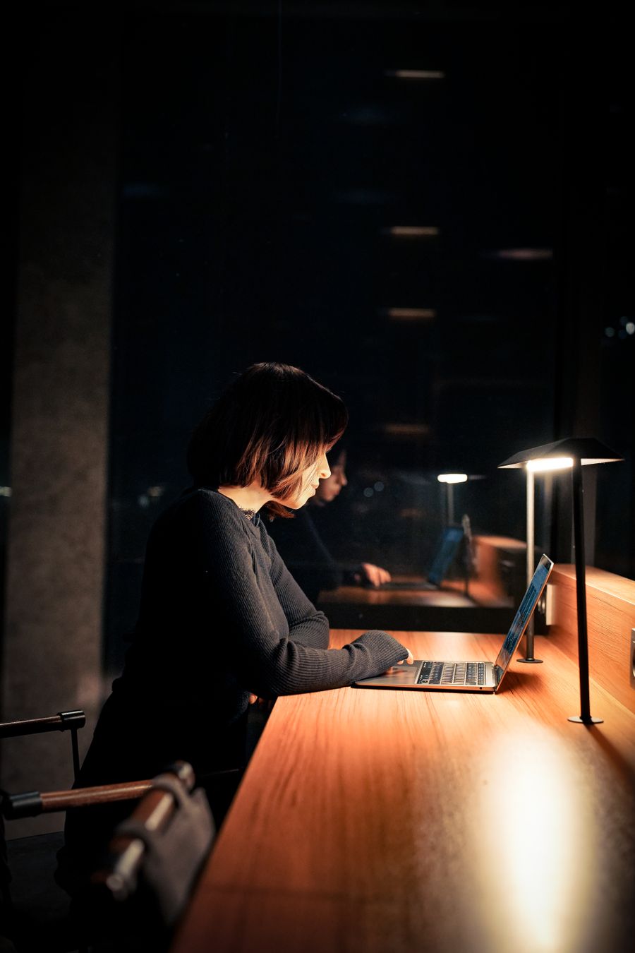 An entrepreneur working at a table with a laptop