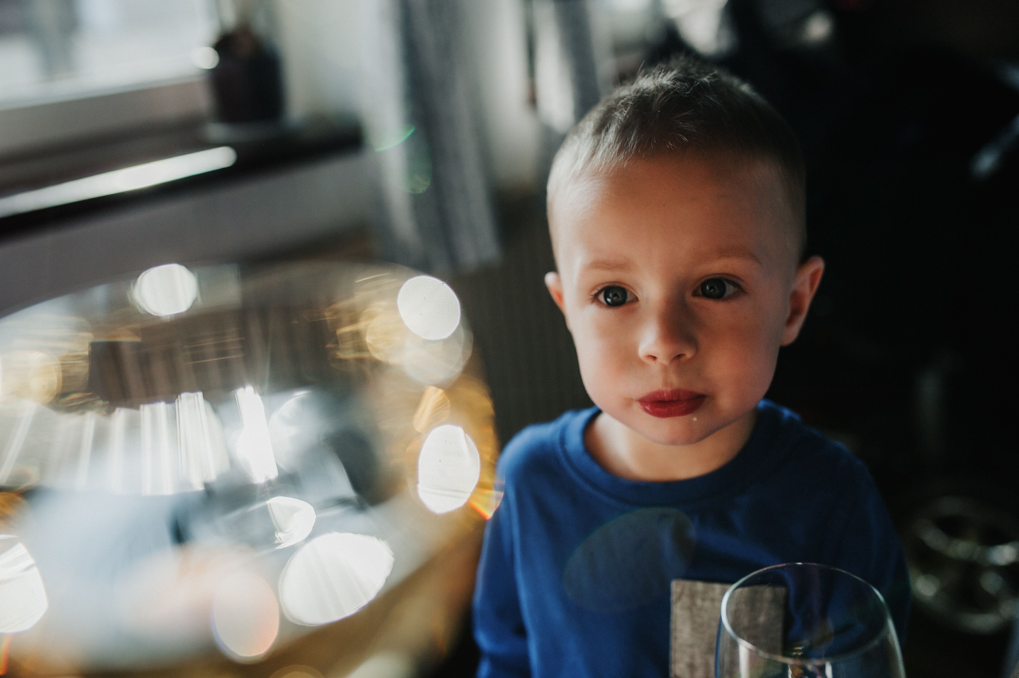 Innocent Child Gazing at Bright Lights Indoors · Free Stock Photo