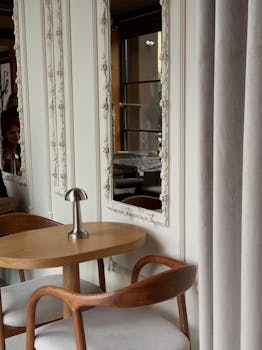 A modern cafe setting with wooden furniture and ornate mirror frames.