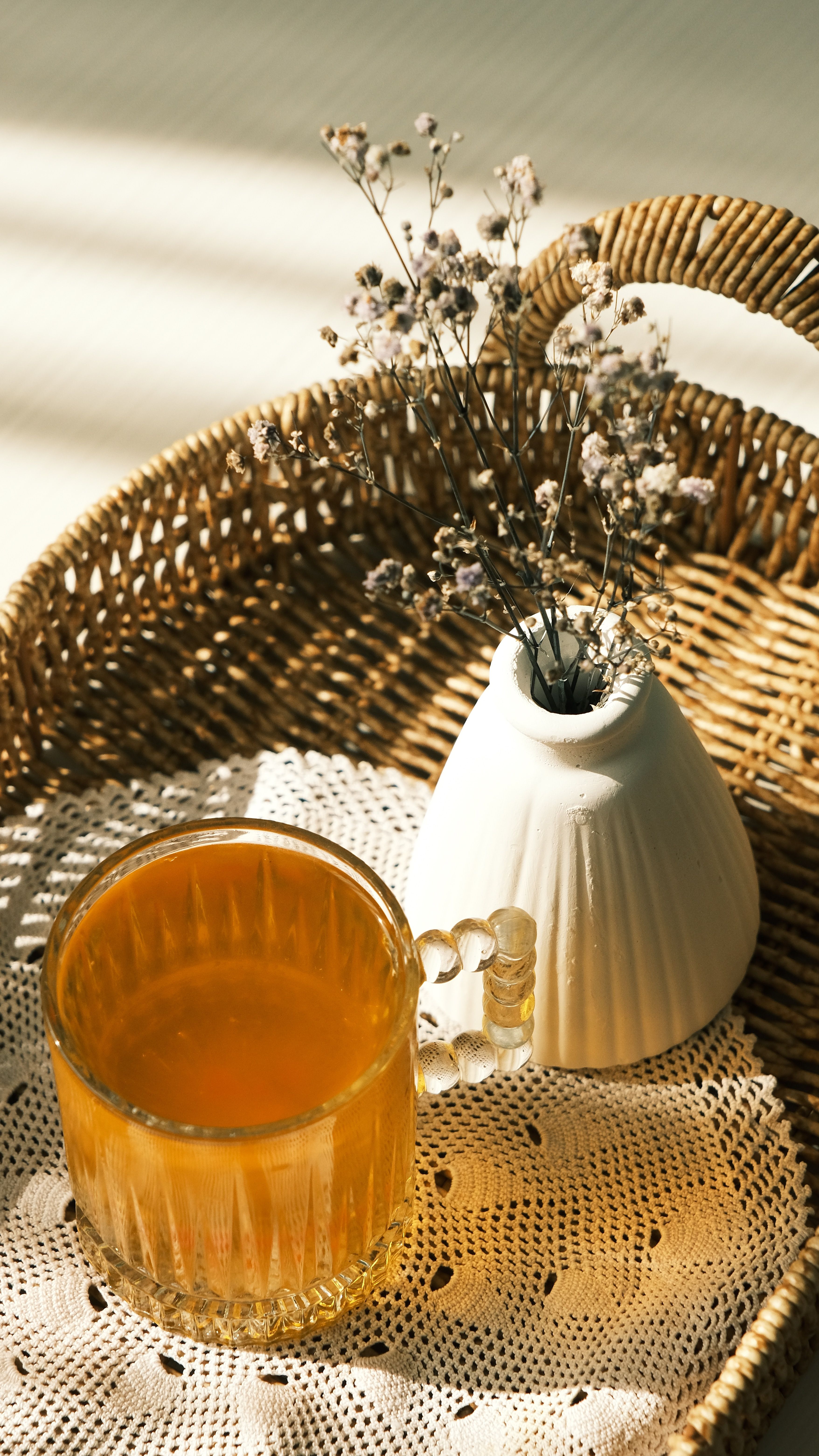 Free Warm morning light on a tea cup and floral arrangement. Stock Photo