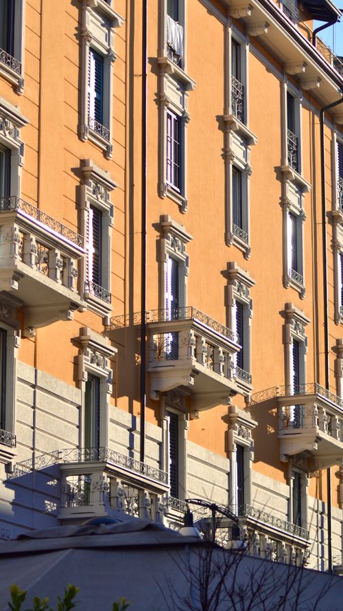 Free Beautiful European residential building with classic architecture and balconies in sunlight. Stock Photo