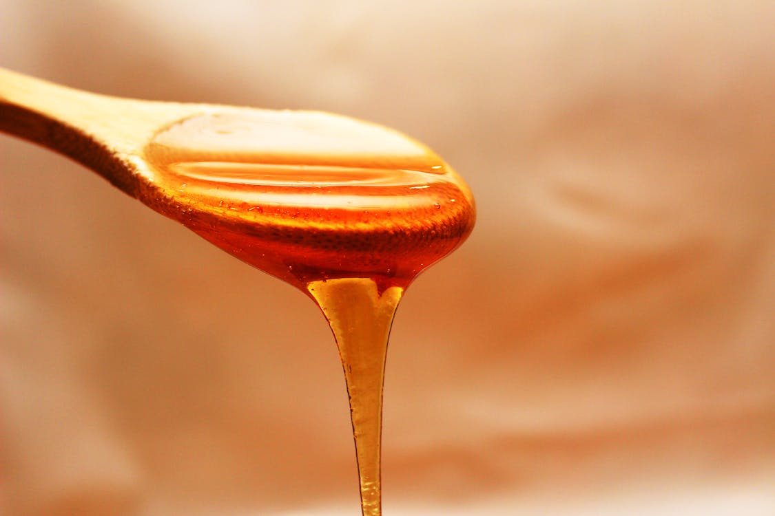 무료 꿀 갈색 나무 숟가락 스톡 사진