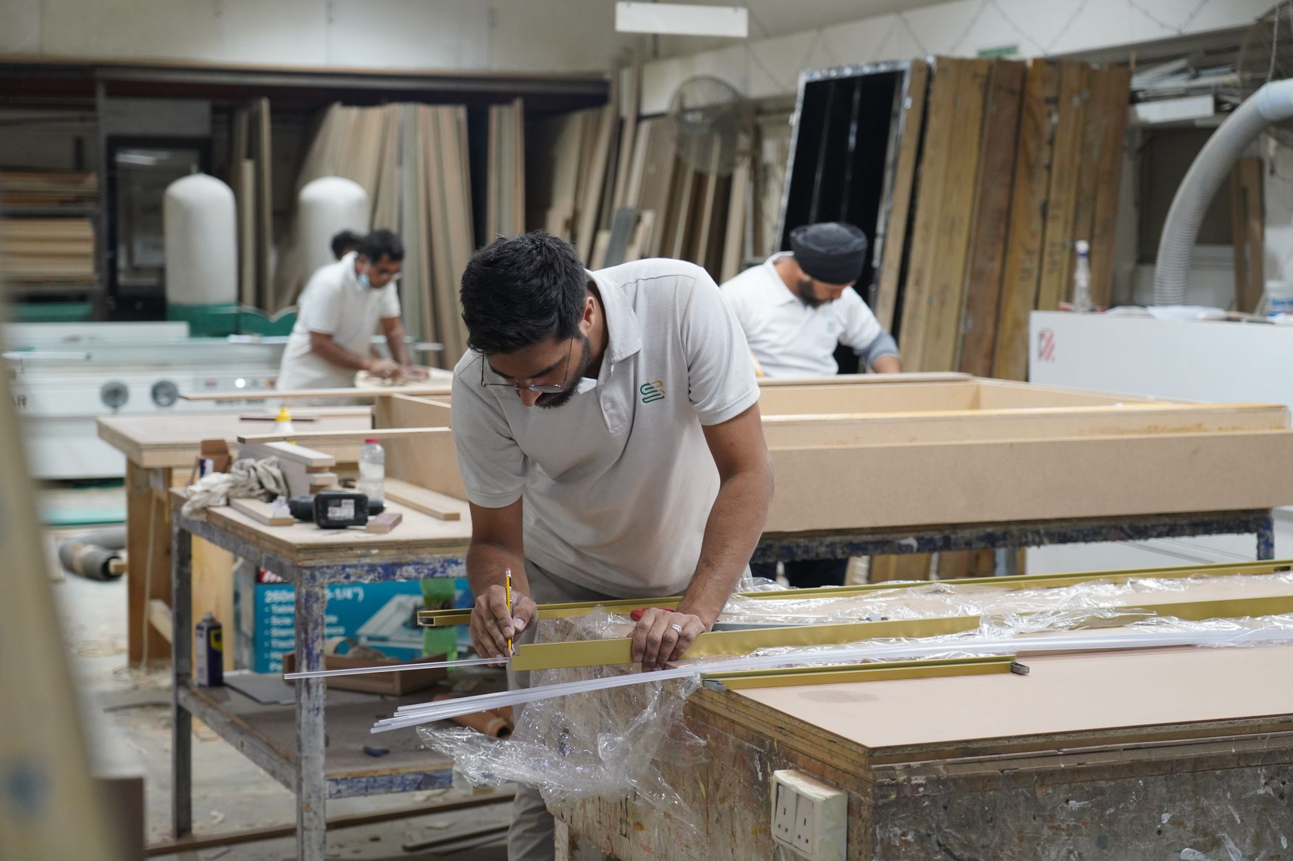 Craftsmen portraying precision and skill in a Dubai carpentry workshop.