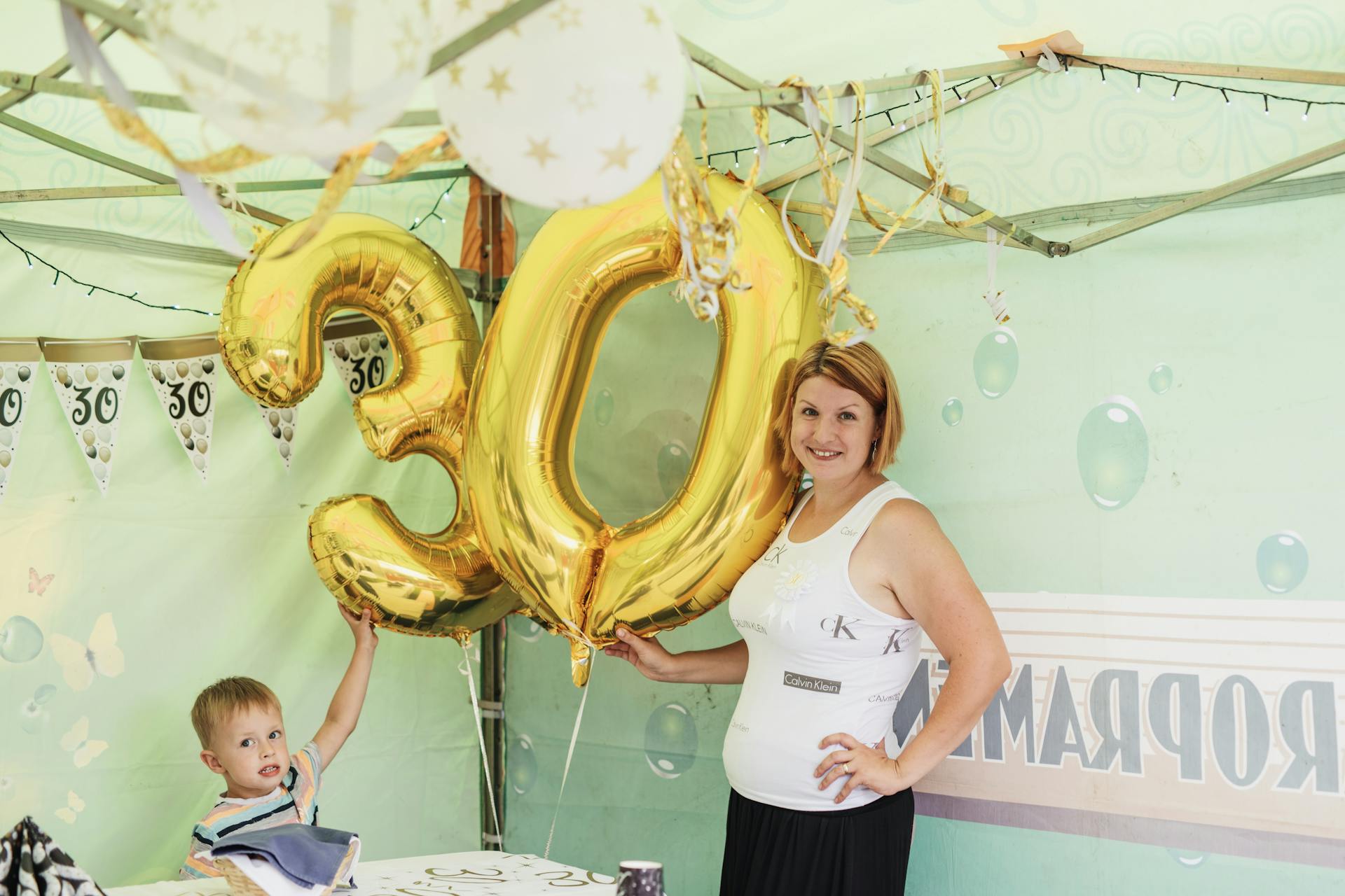 A cheerful 30th birthday party featuring gold balloons and decorations.