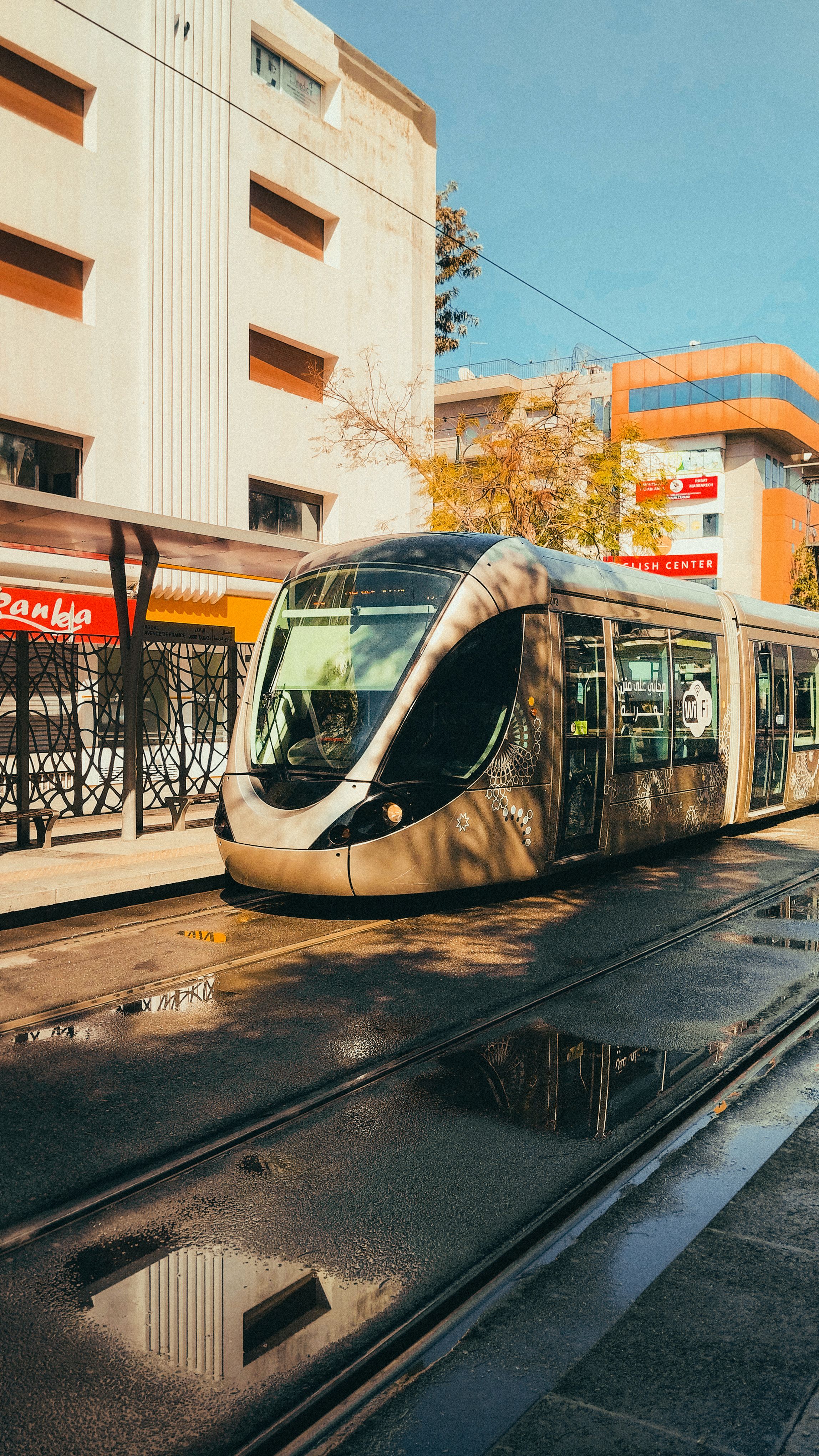 Modern Tram in Rabat with Reflections on Wet Pavement · Free Stock Photo