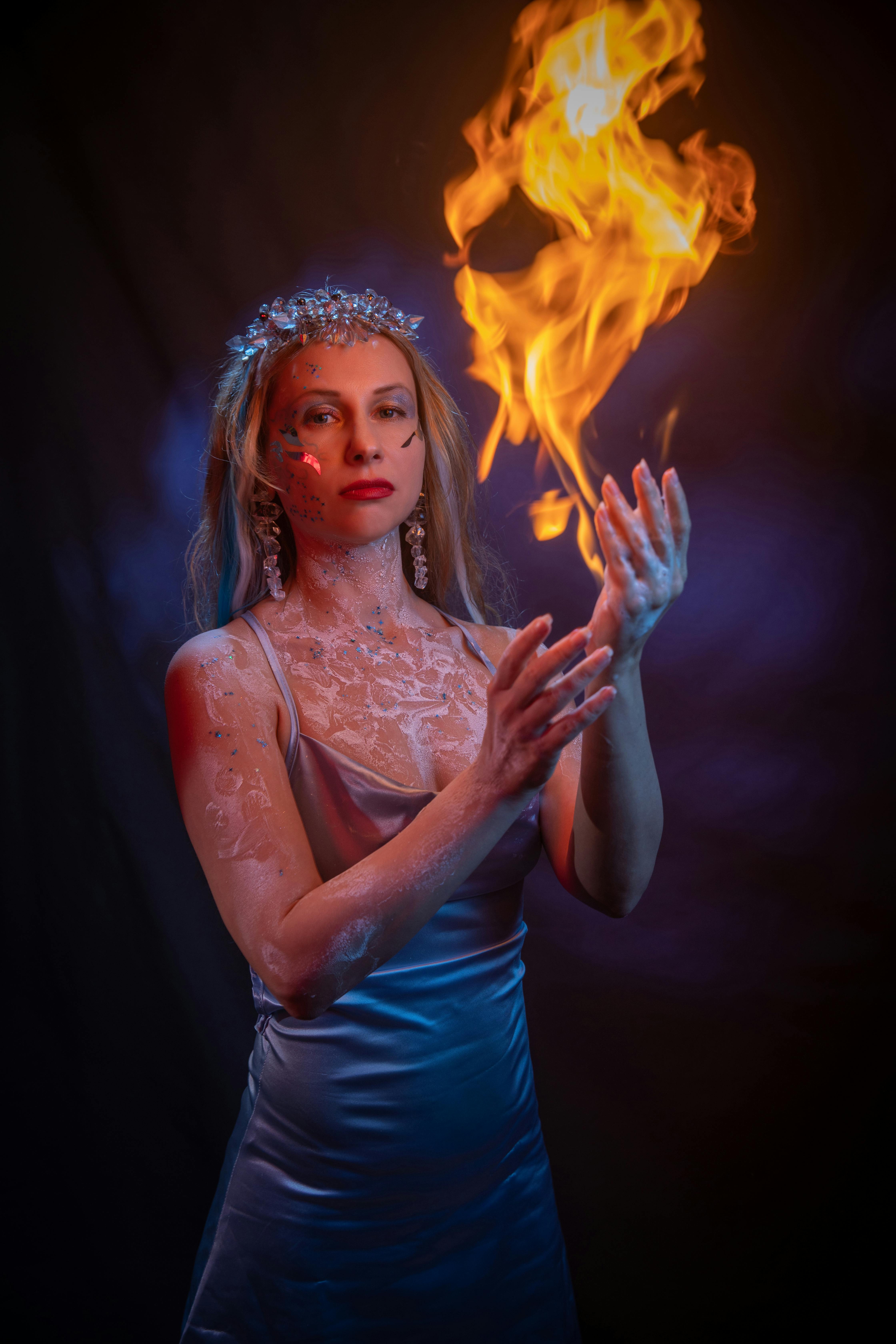 A captivating portrait of a woman holding a flame, symbolizing magic.