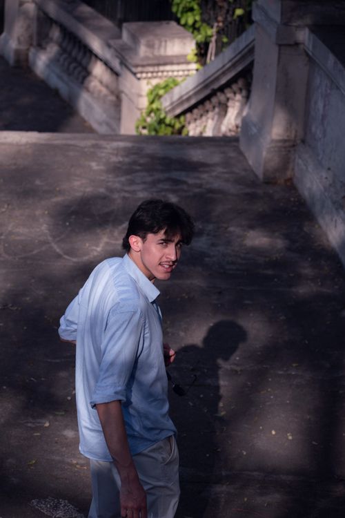 Free Stylish young man in natural light on Buenos Aires street, warm summer day. Stock Photo