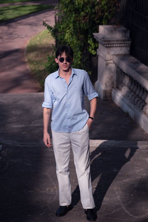 Free Young man in blue shirt and sunglasses enjoying a sunny day in Buenos Aires park. Stock Photo