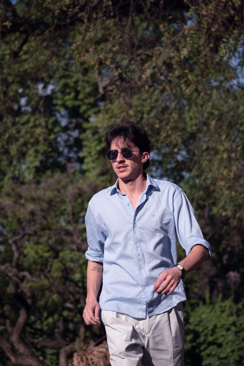 Free Casual young man in sunglasses enjoying a sunny day in Buenos Aires park. Stock Photo