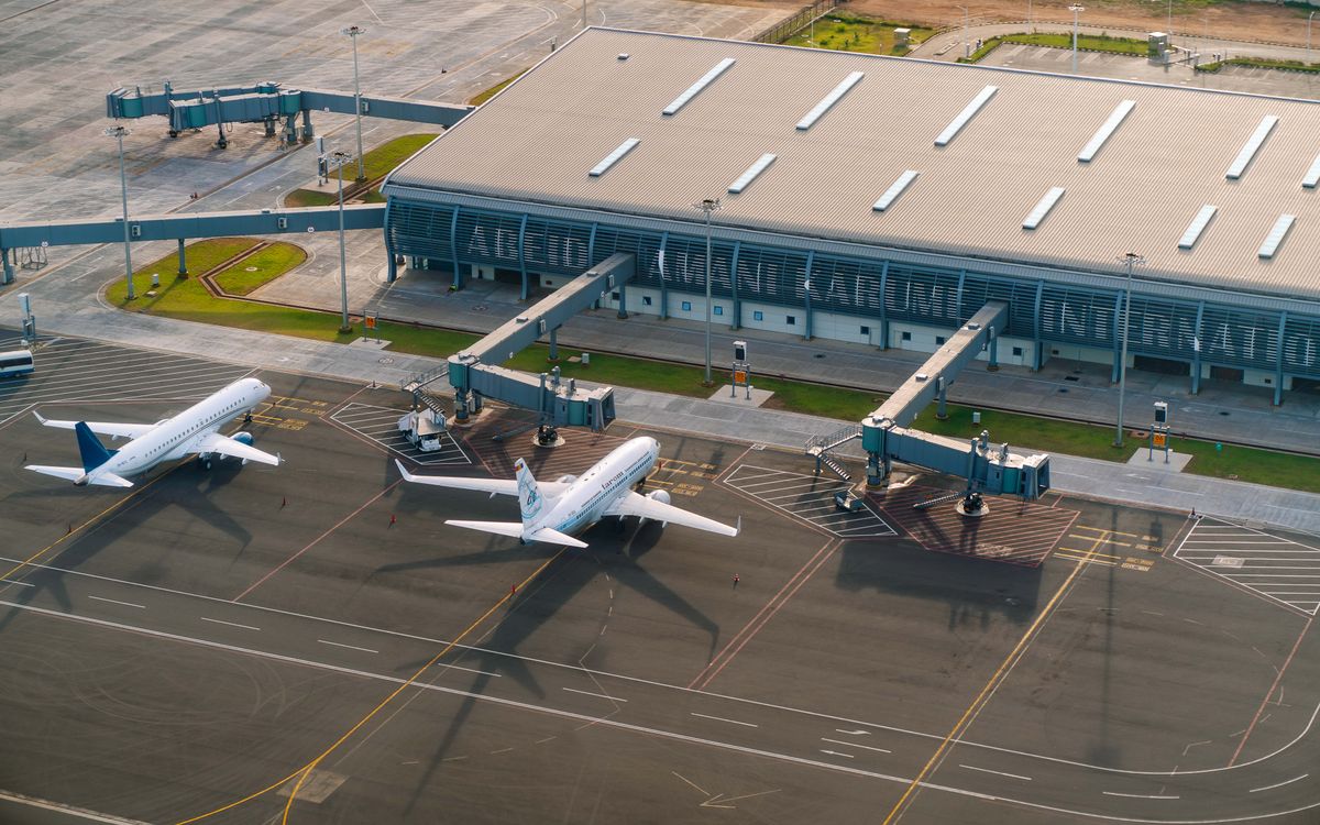 Aerial view of Abeid Amani Karume International Airport in Zanzibar, showing parked airplanes and terminal.