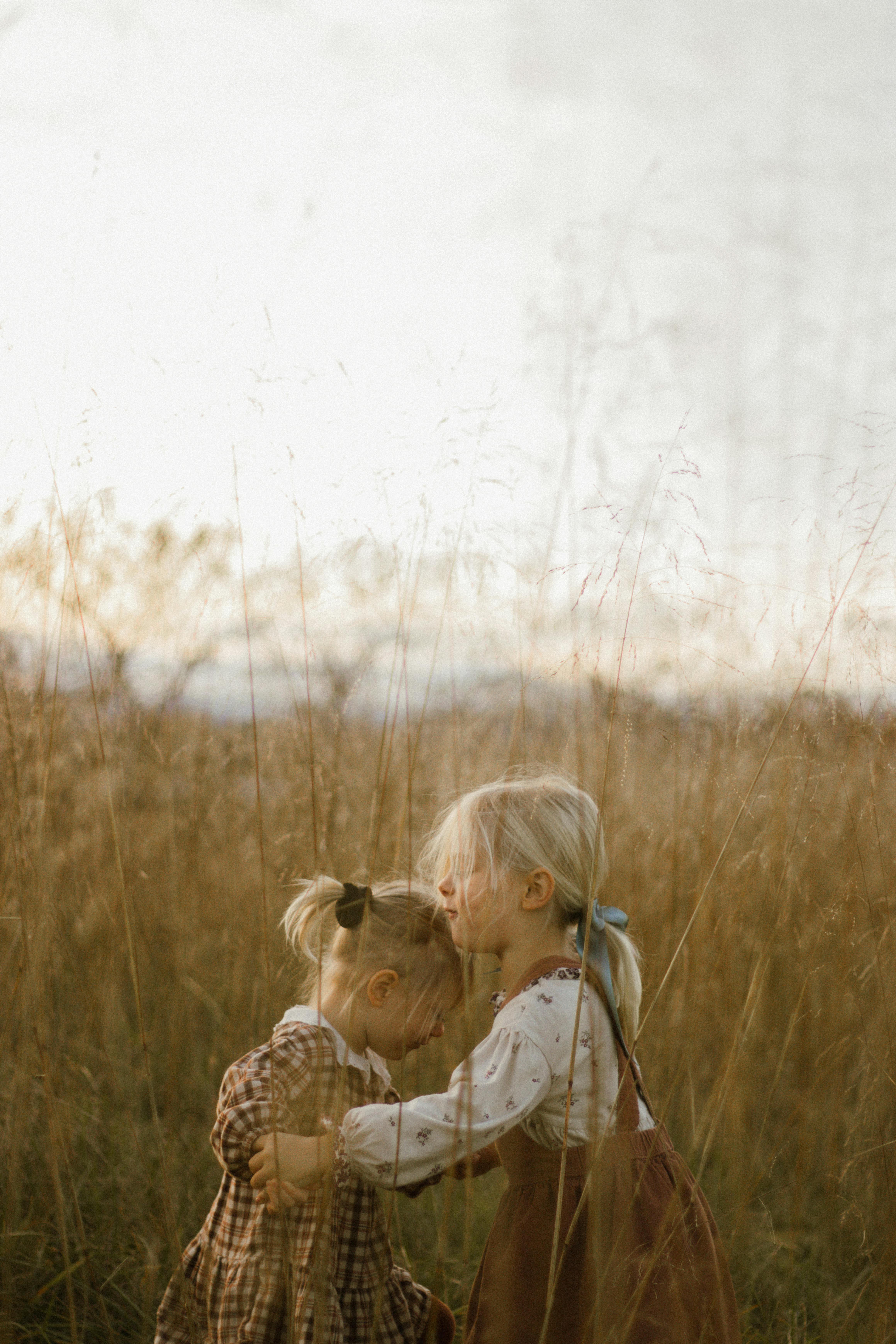 tender sisterly moment in autumn field