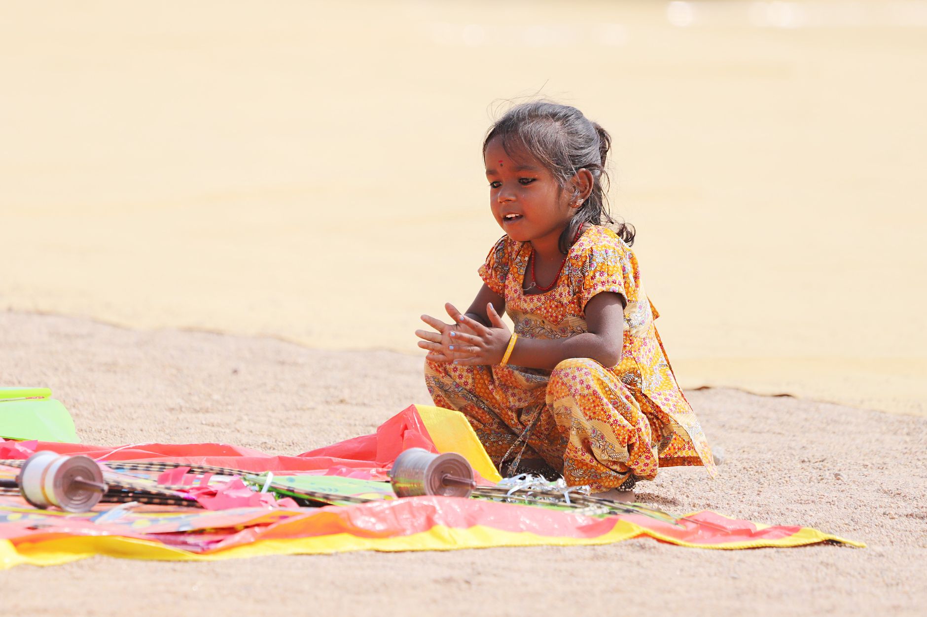 Indian family playing a low-stakes Three Patti game during Diwali, cards and modest chips on a wooden table