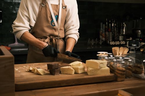 Free Barista slicing assorted gourmet chocolates in a cozy Konya café setting. Stock Photo