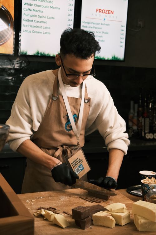 Free Barista skillfully chopping chocolate at a trendy café in Konya, Türkiye. Stock Photo