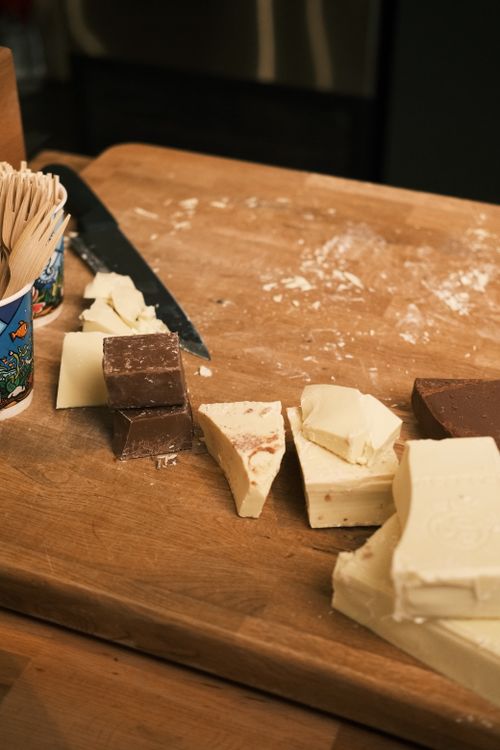 Free Variety of chocolate pieces on a wooden board, perfect for gourmet treats and desserts. Stock Photo