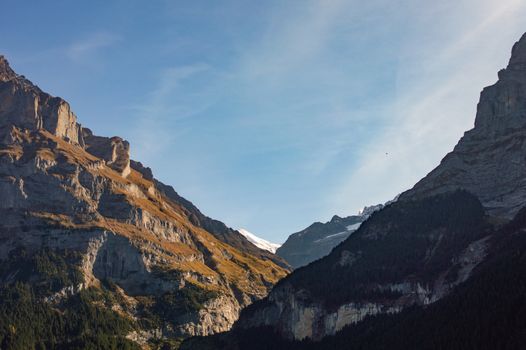 Serene mountain view with clear blue sky and rugged peaks, capturing natural beauty.