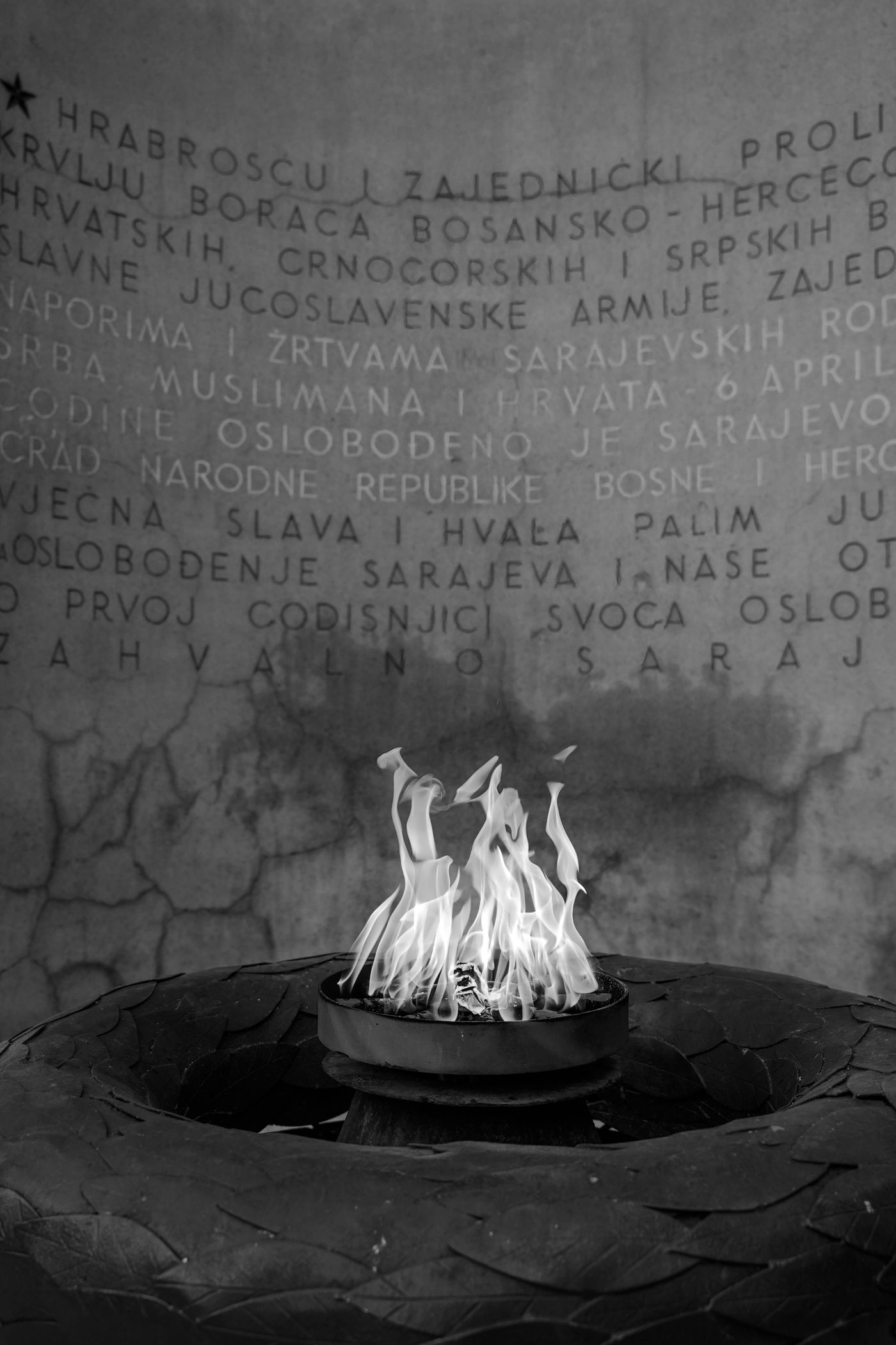 Black and white photo of the Eternal Flame war memorial in Sarajevo
