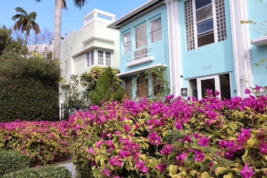 Art Deco architecture with vibrant bougainvillea in a sunny garden setting.