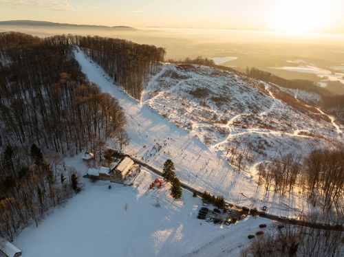 Free A scenic winter aerial view of snowy hills and surrounding forest in Daruvar, Croatia at sunset. Stock Photo