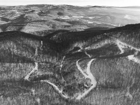 Black and white aerial view of snow-covered hills in Daruvar, Croatia.