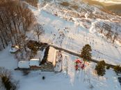 A stunning aerial view of a snowy landscape with people enjoying winter activities in Daruvar, Croatia.